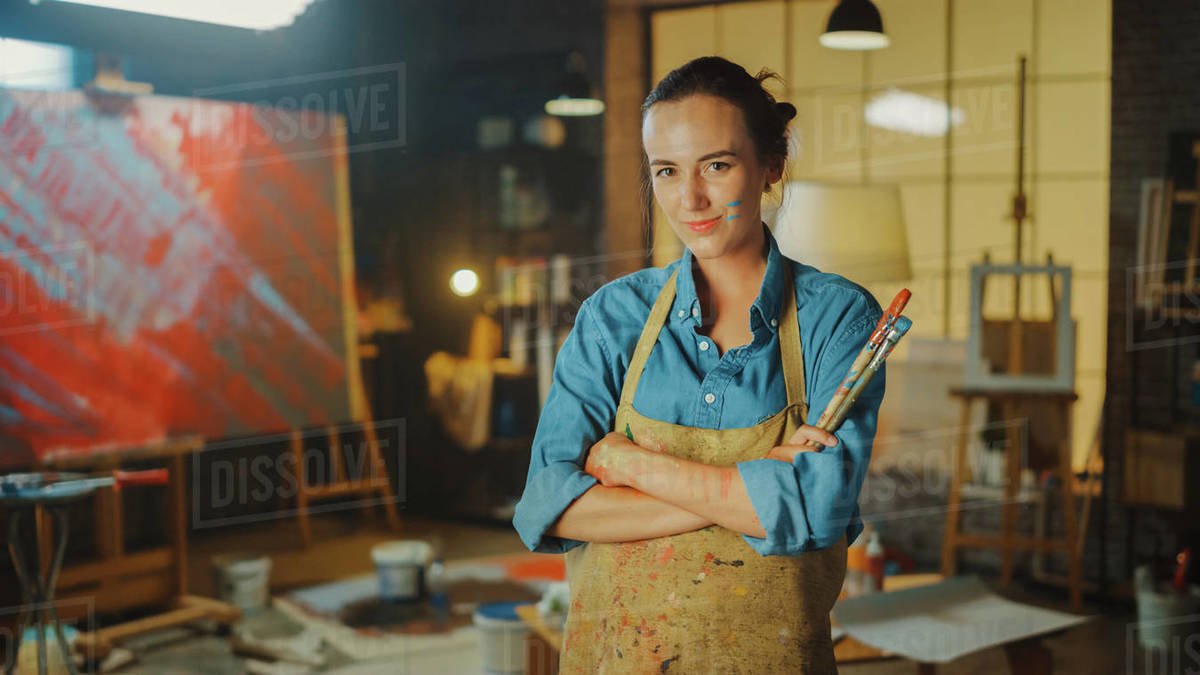 Professional Young Female Artist Dirty with Paint, Wearing Apron, Arms