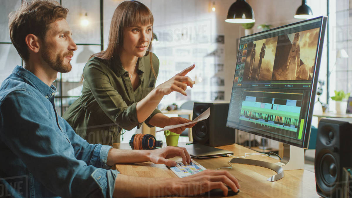 Beautiful Female Art Director Consults Handsome Video Editor Colleague