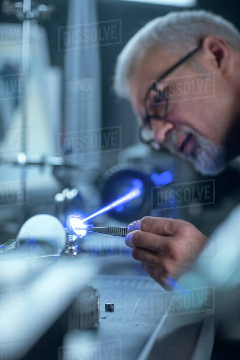 Portrait of Focused Middle Aged Engineer in Glasses Working with High