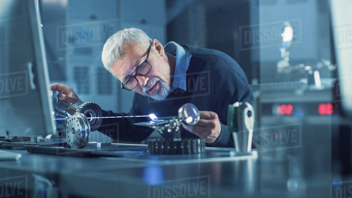 Portrait of Focused Middle Aged Engineer in Glasses Working with High