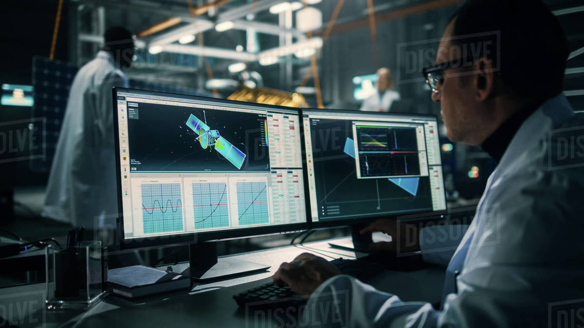 Male Engineer Uses Computer while Working on Satellite Construction ...