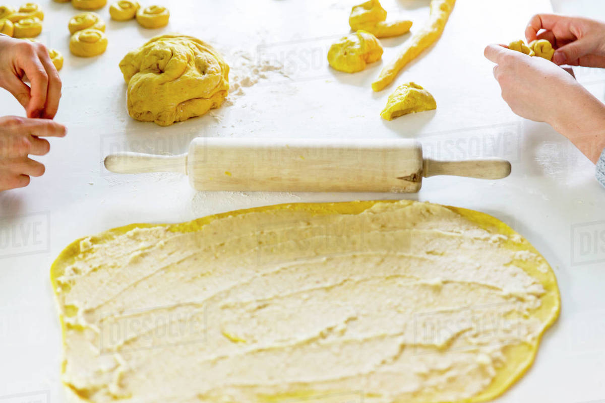 Children making saffron rolls Stock Photo Dissolve