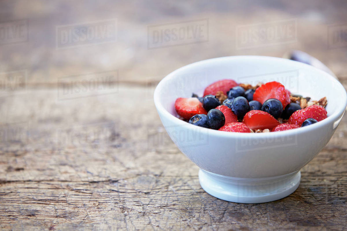 Fruits with muesli in bowl Stock Photo Dissolve