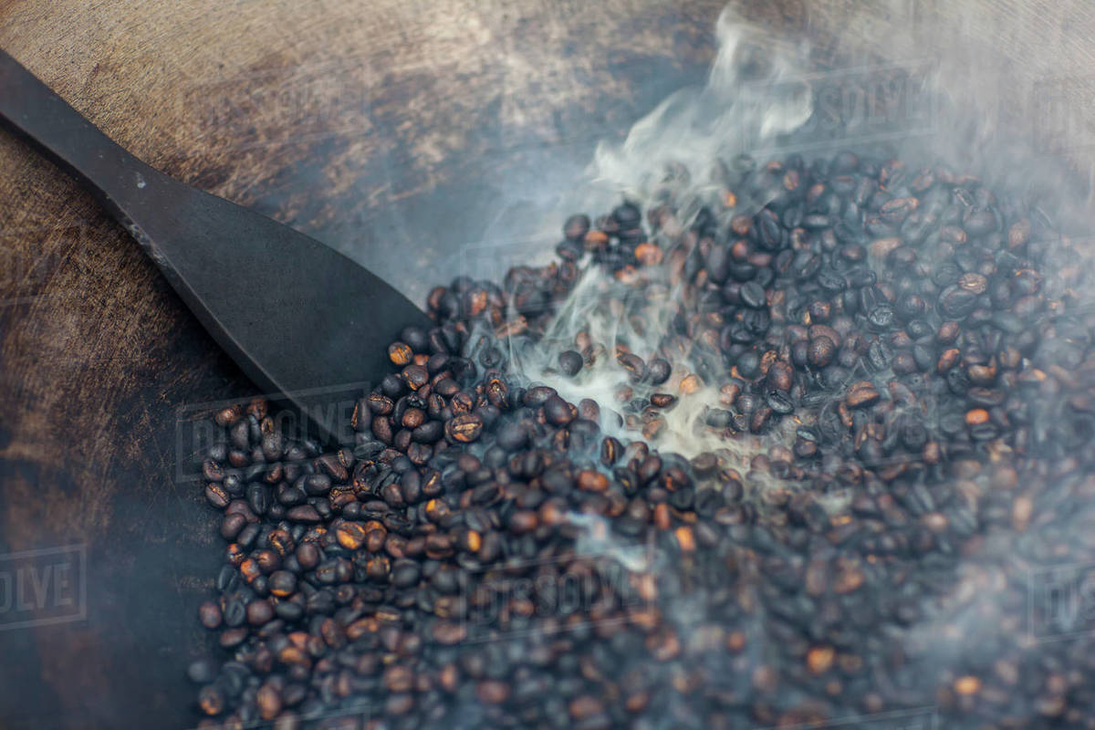 Coffee Beans Being Roasted By Hand In A Wok By The Coffee Pickers