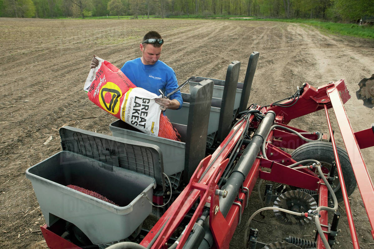 Agriculture A fourth generation farmer fills the seed hoppers of his
