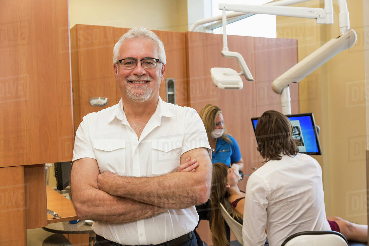 Dentist posing during patient consultation; Edmonton, Alberta, Canada