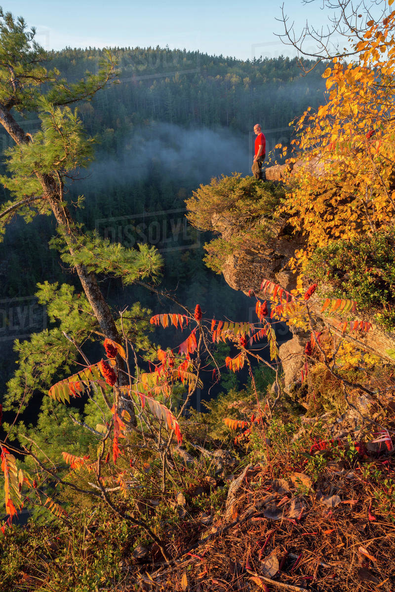 Man standing on the edge of the Barron Canyon, Algonquin Park