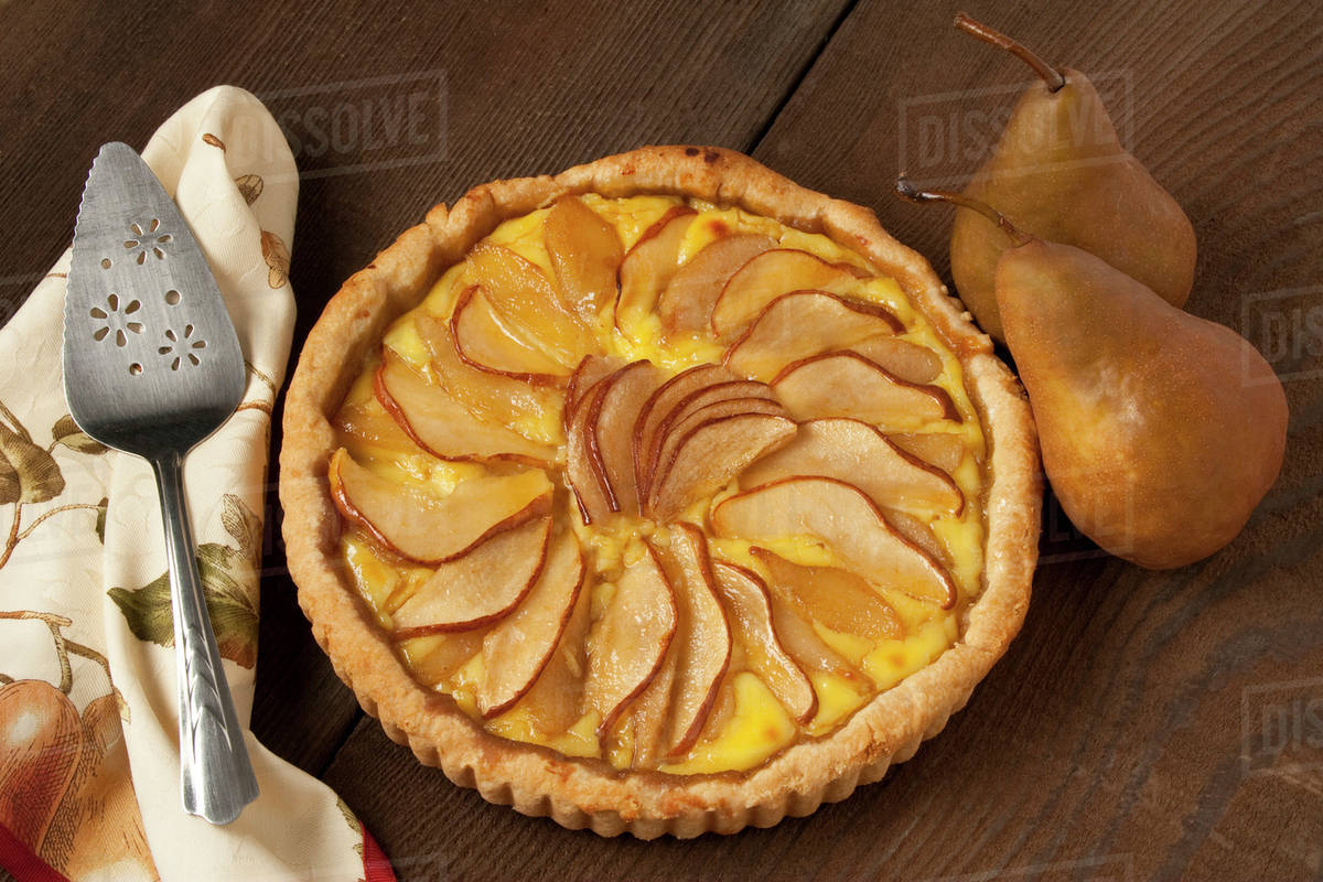 Food Pear Custard Pie topped with Bosc pear slices. Stock Photo