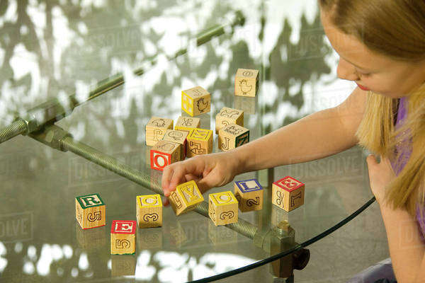 Young Girl Spelling Recycle With Alphabet Blocks - Royalty-free Stock ...