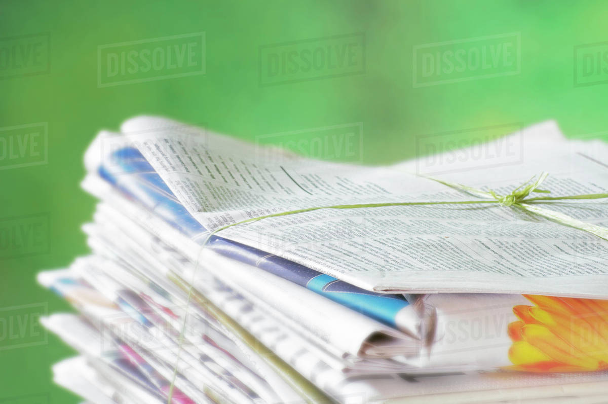 Newspapers Tied Into A Pile For The Recycle Bin. Stock Photo Dissolve
