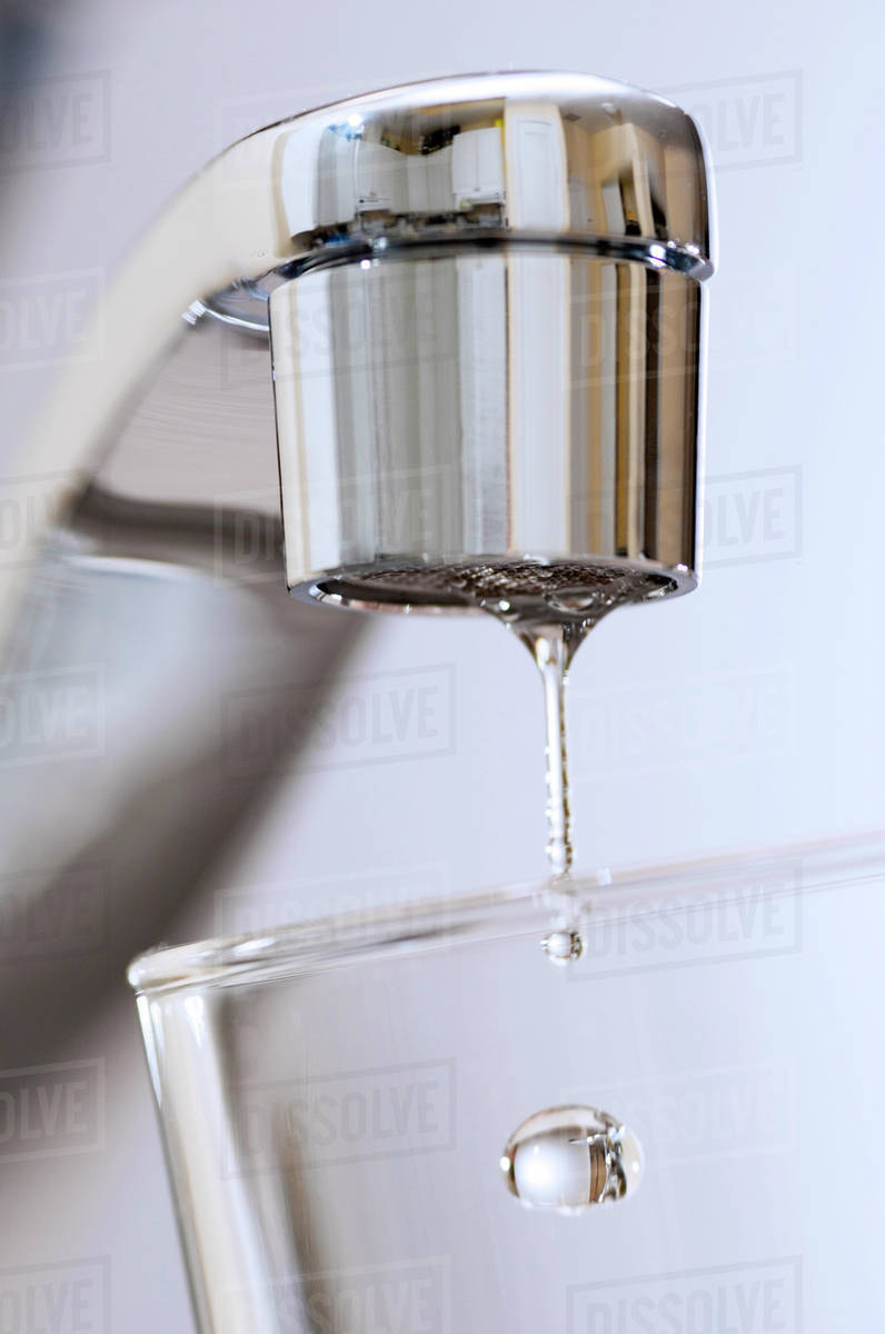 Water Drips From Kitchen Tap. Stock Photo Dissolve