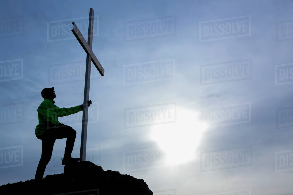 A Man Looks Up At Cross Located At The Top Of Mt. Tzouhalem In The Cowichan Valley; British