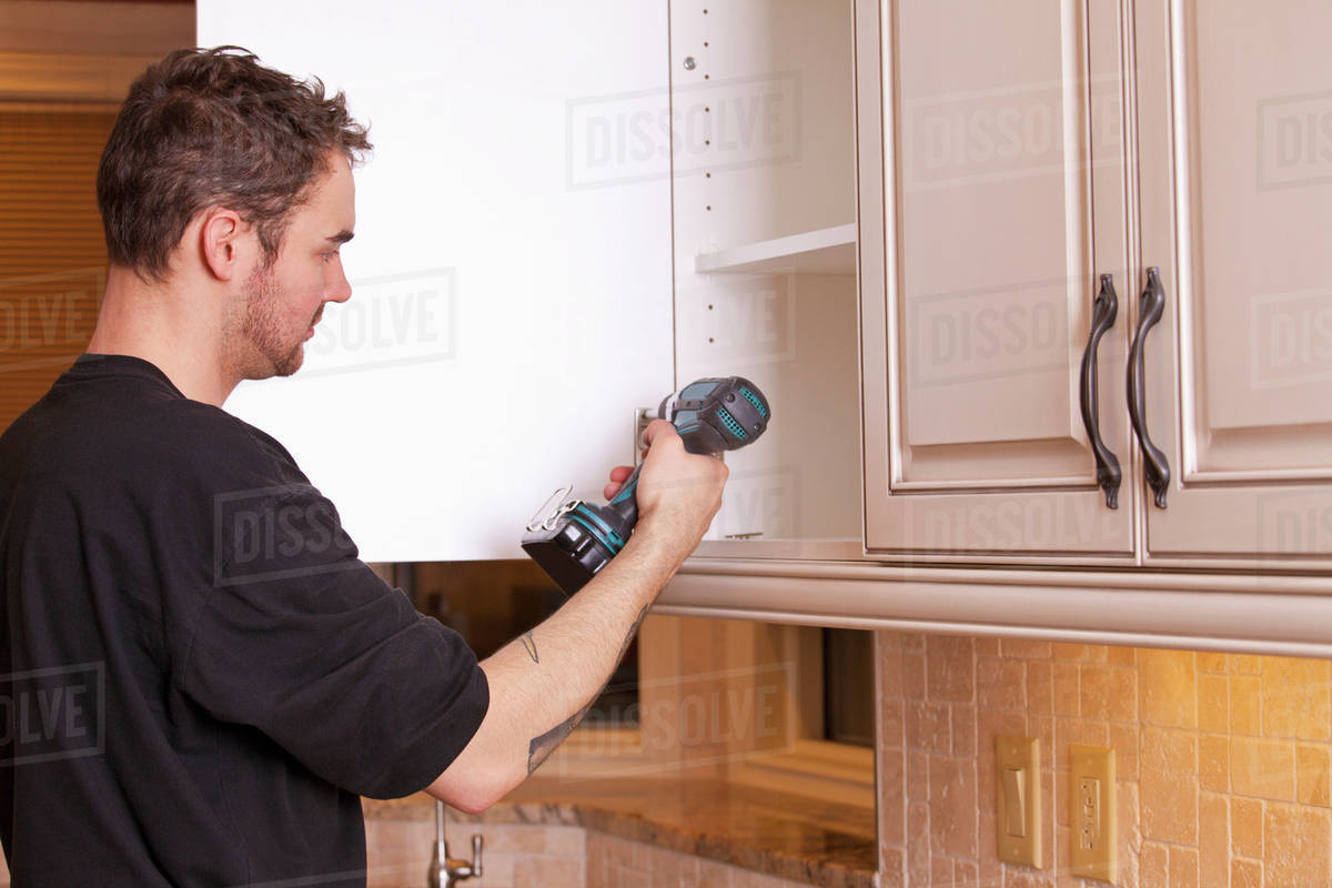 Carpenter Installing New Kitchen Stock Photo Dissolve