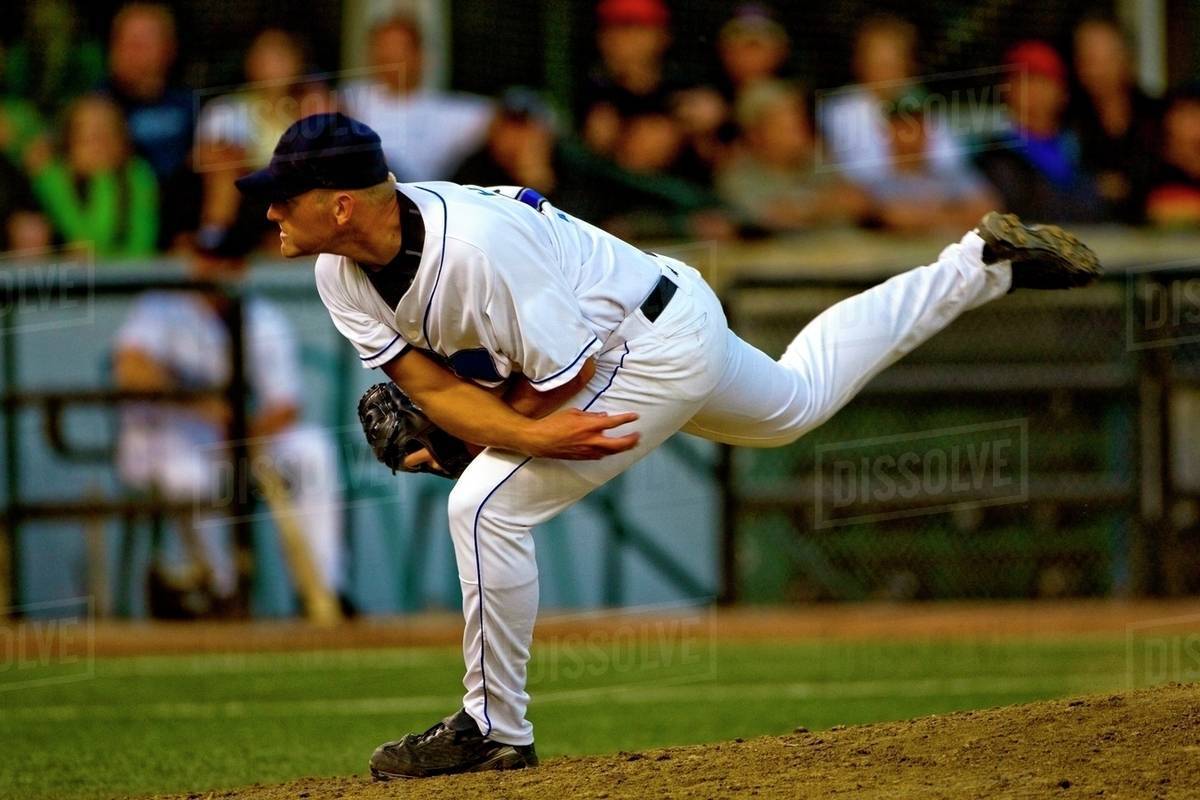 Baseball Player Throwing The Ball - Stock Photo - Dissolve
