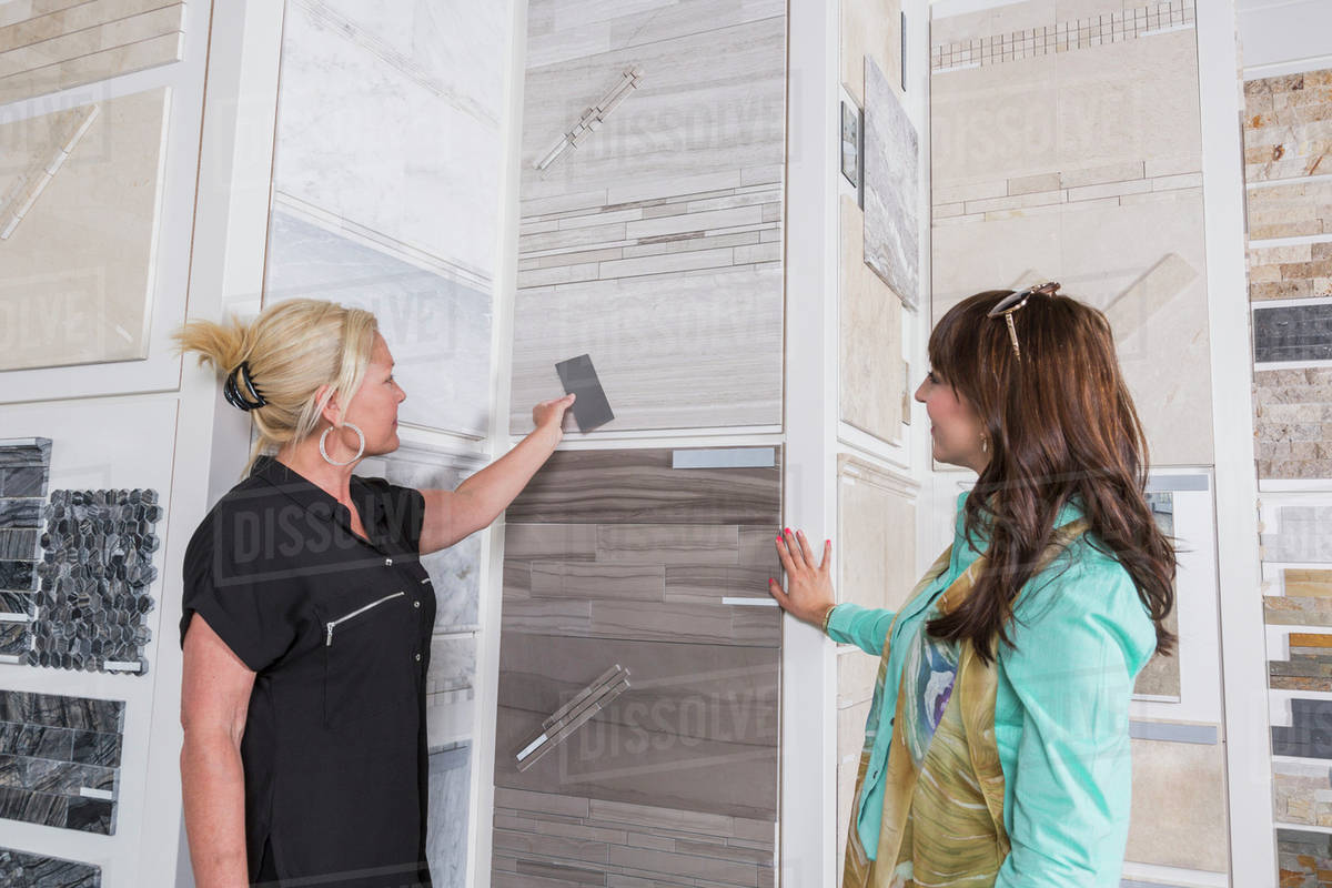 Design consultant and interior designer selecting tiles in showroom of tile store; Edmonton, Alberta, Canada Royalty-free stock photo