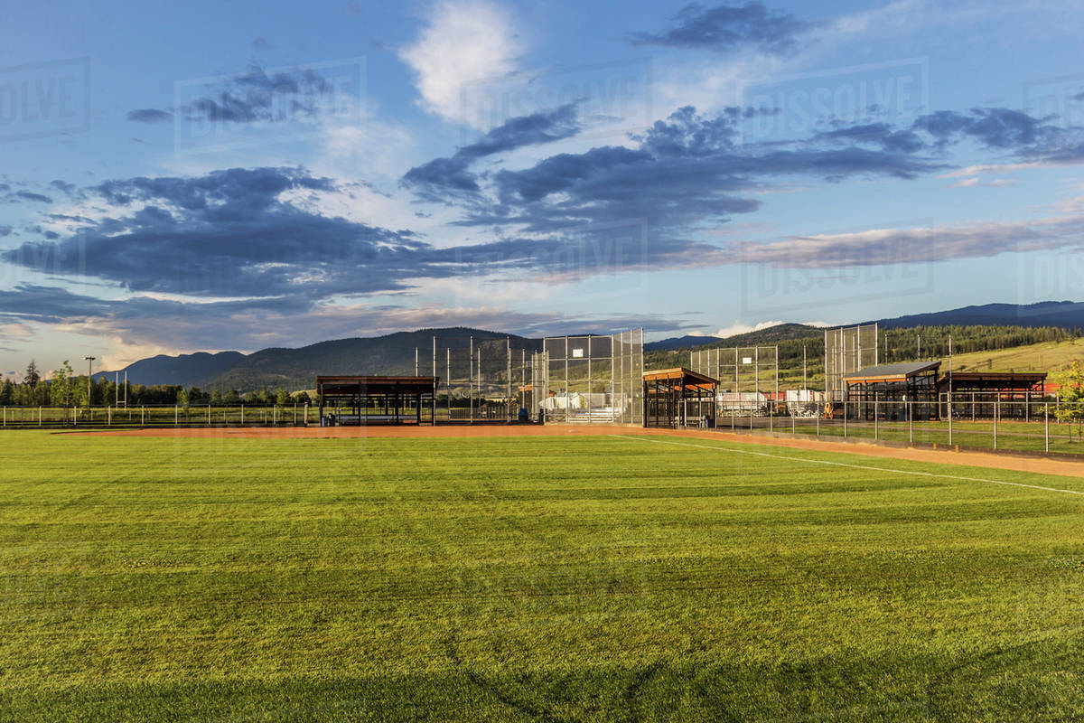 A bright colourful new baseball diamond shown in late afternoon under