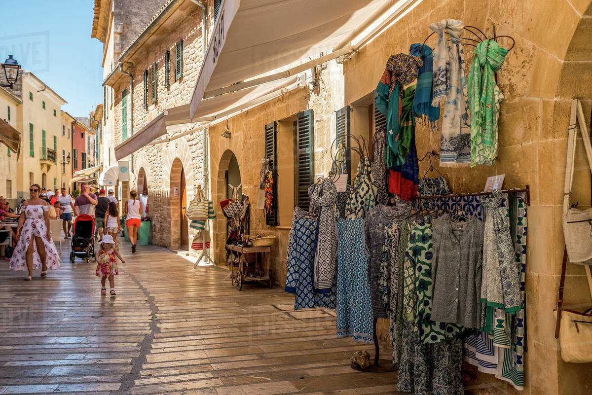 Small shops along a narrow street; Alcudia, Mallorca, Balearic Islands