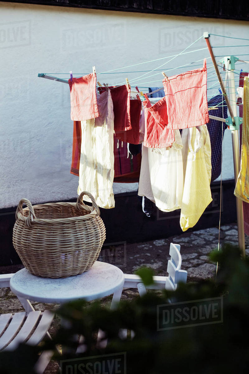 Laundries hanging on clothesline outside house Stock Photo Dissolve