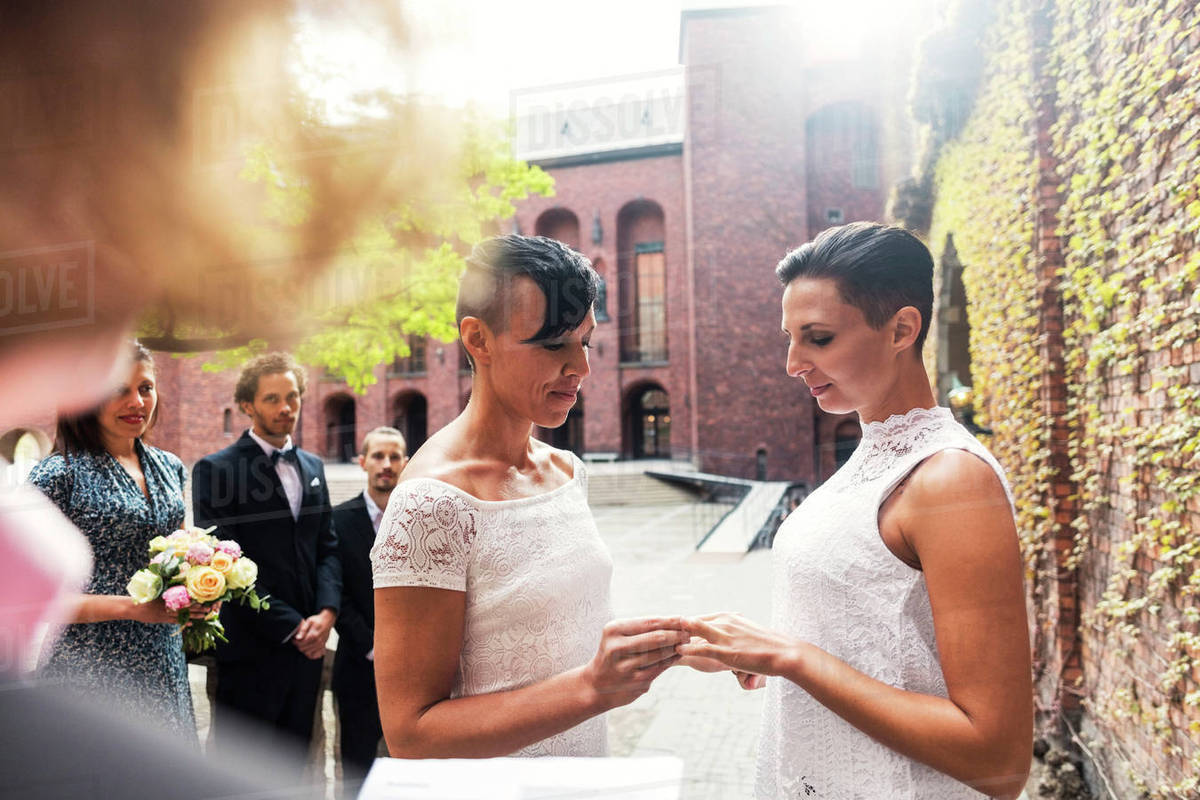 Lesbian couple exchanging rings during wedding ceremony Royalty-free stock photo