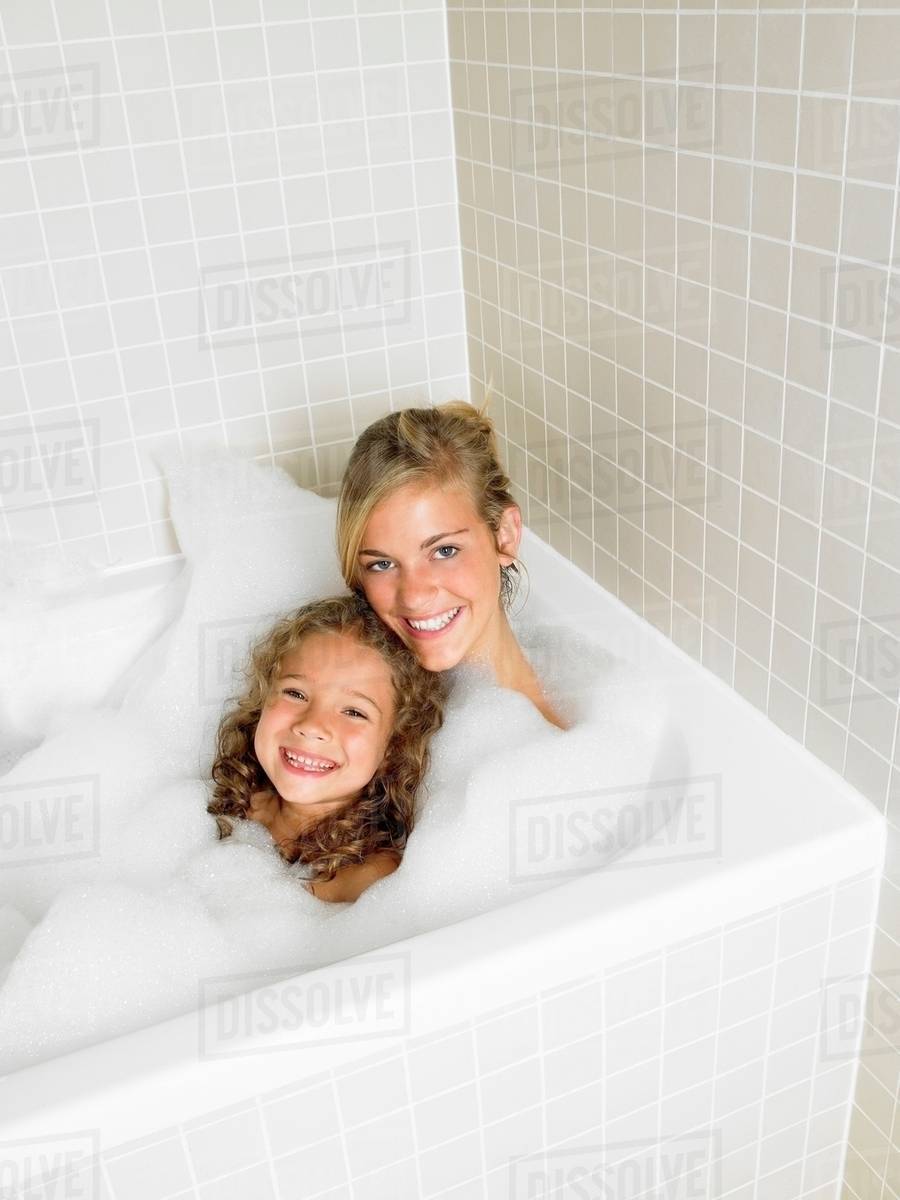 Sisters in a bath, foam Stock Photo Dissolve