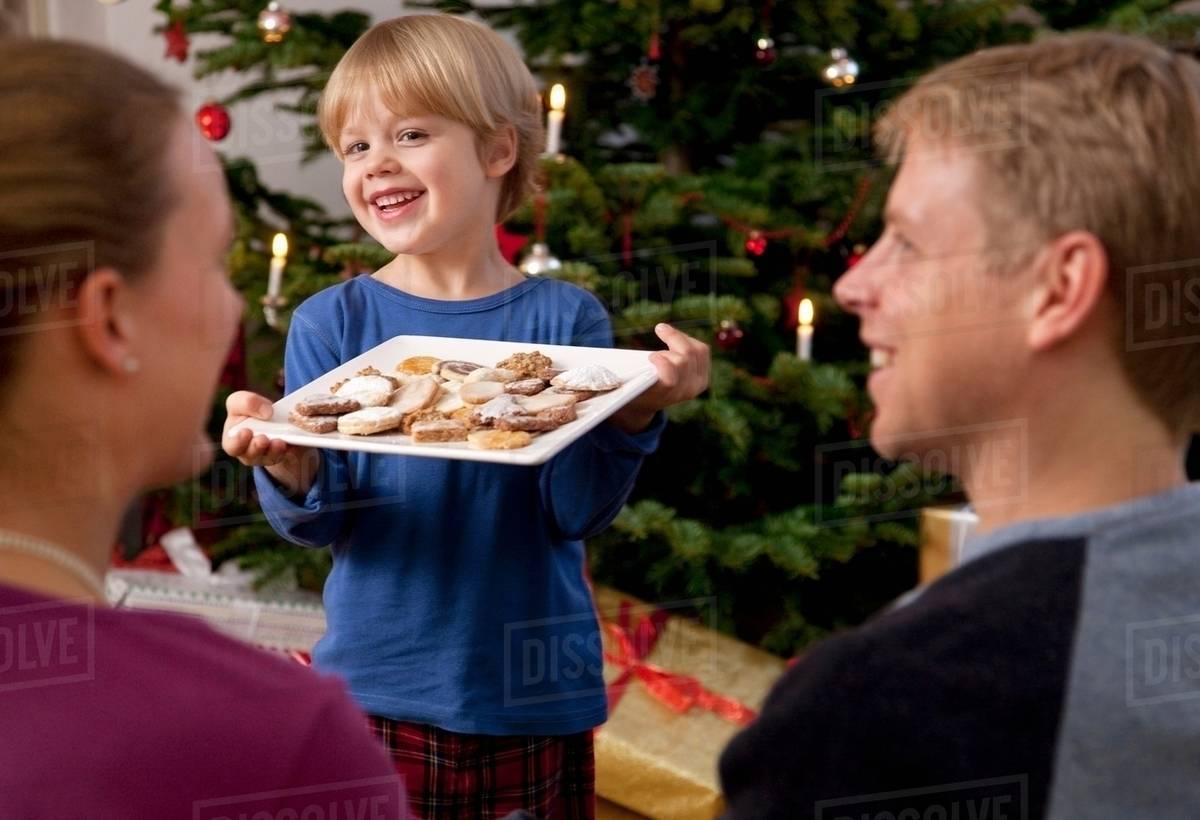 Boy presents plate of homemade biscuits Stock Photo Dissolve