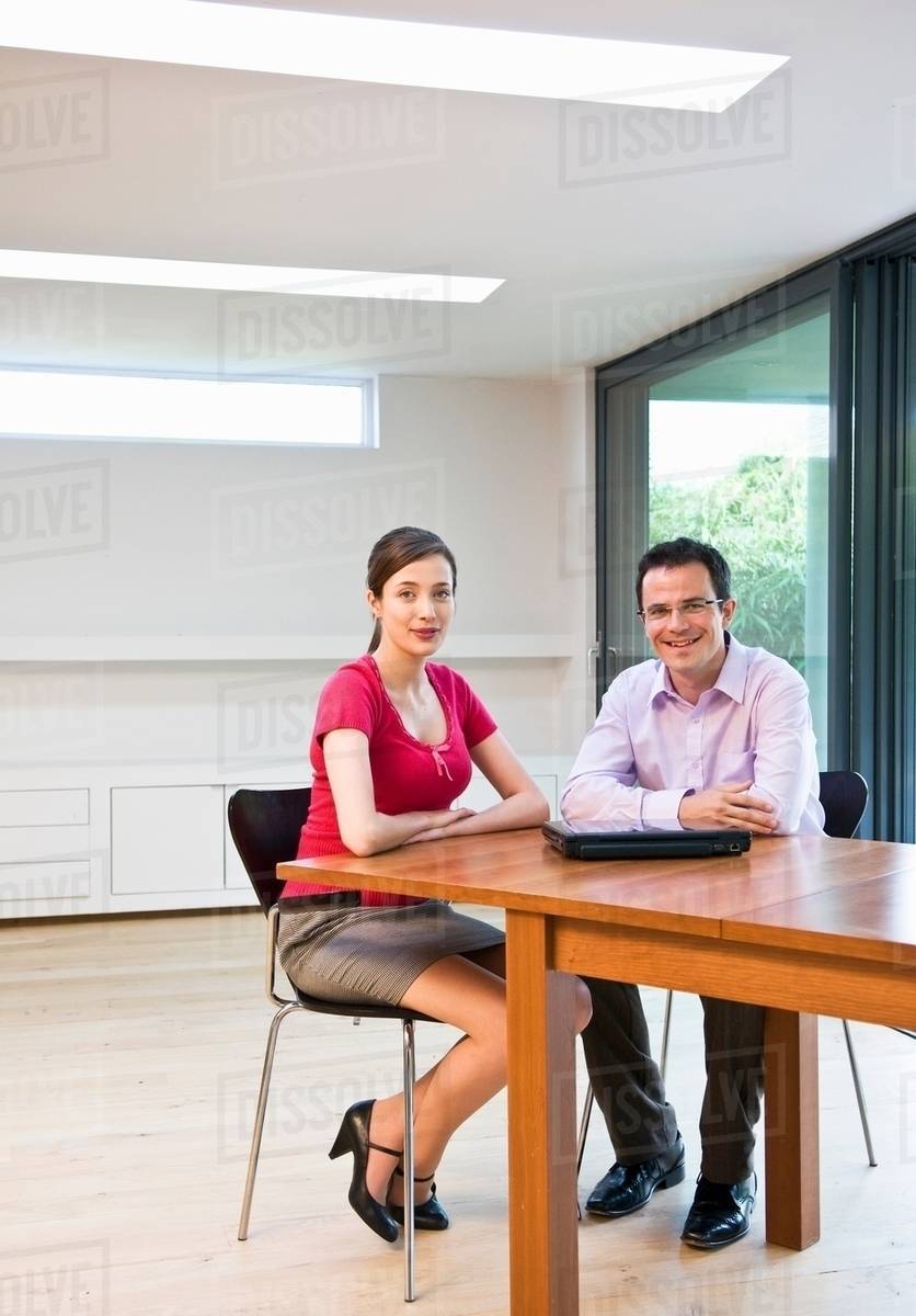 Confident man & woman in modern office - Stock Photo - Dissolve