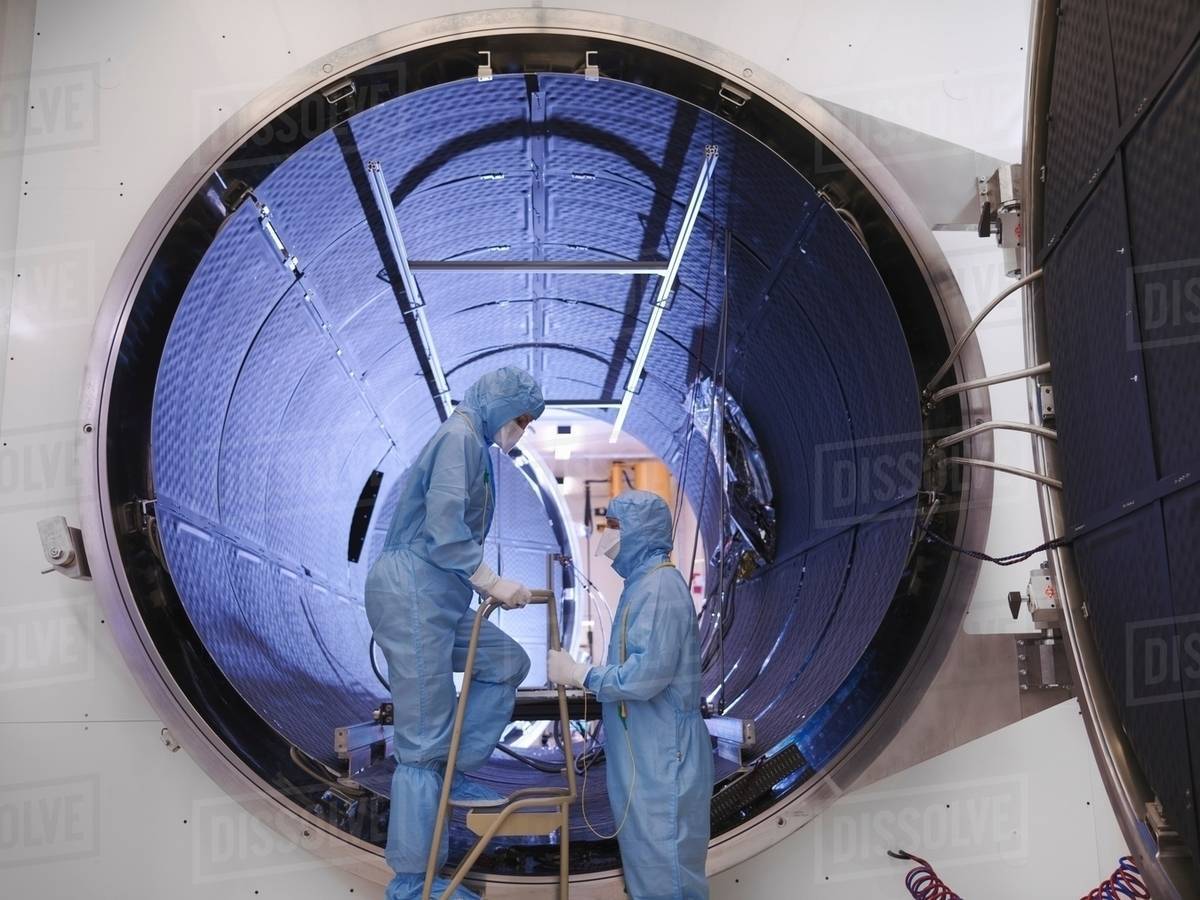 Workers with satellite testing chamber Stock Photo Dissolve