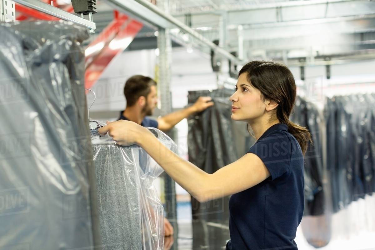 Warehouse workers preparing garment orders in distribution warehouse Stock Photo Dissolve