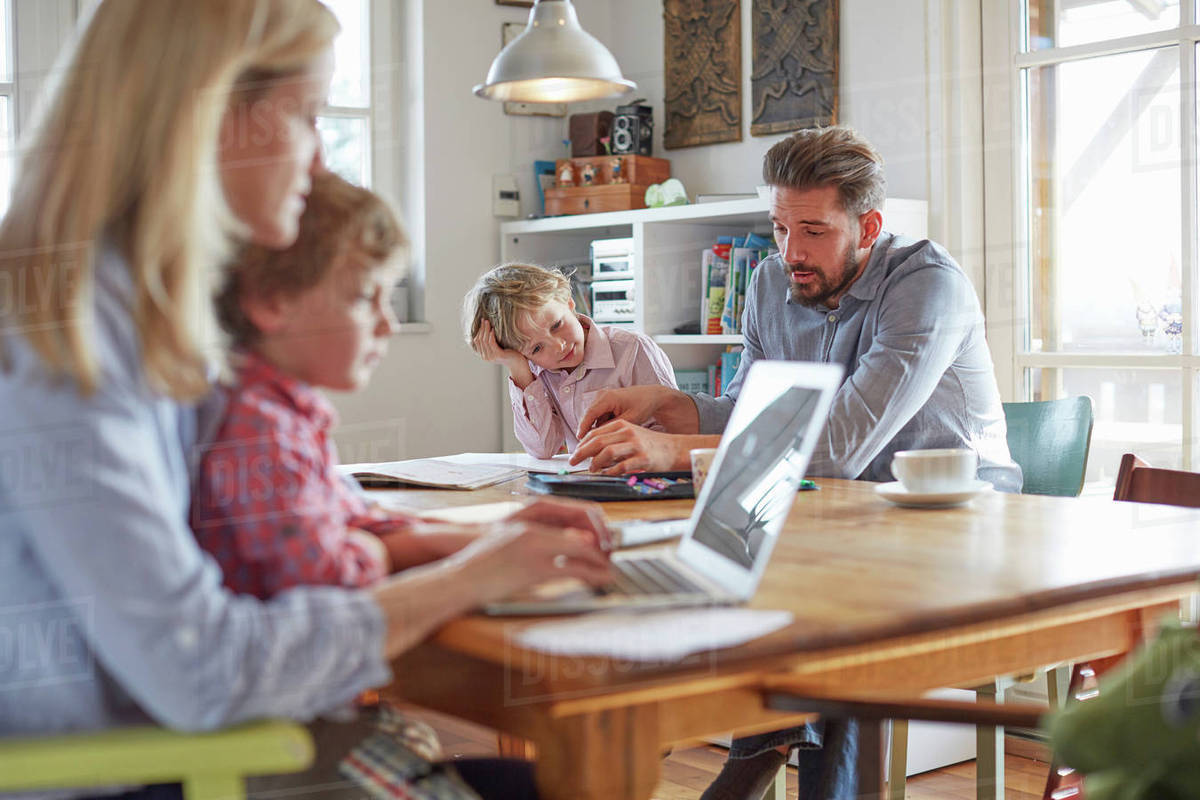 Parents and sons working in home office Stock Photo Dissolve
