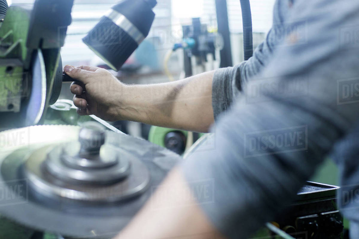 Man working in grinding Stock Photo Dissolve