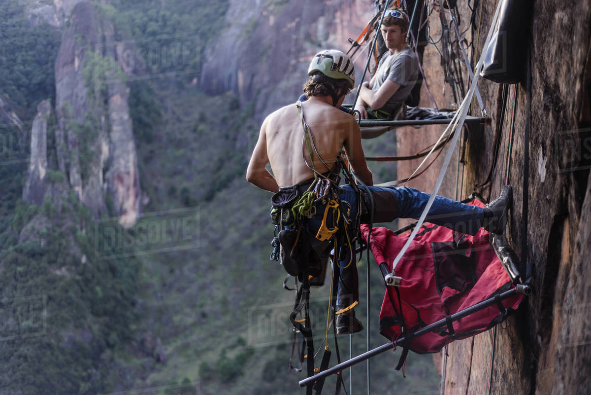 Rock climber securing portaledge, Liming, Yunnan Province, China