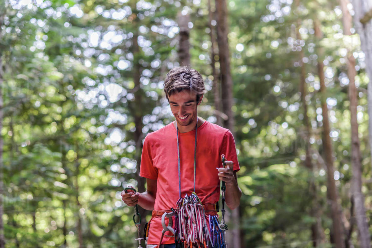 Happy rock climber in forest Stock Photo Dissolve