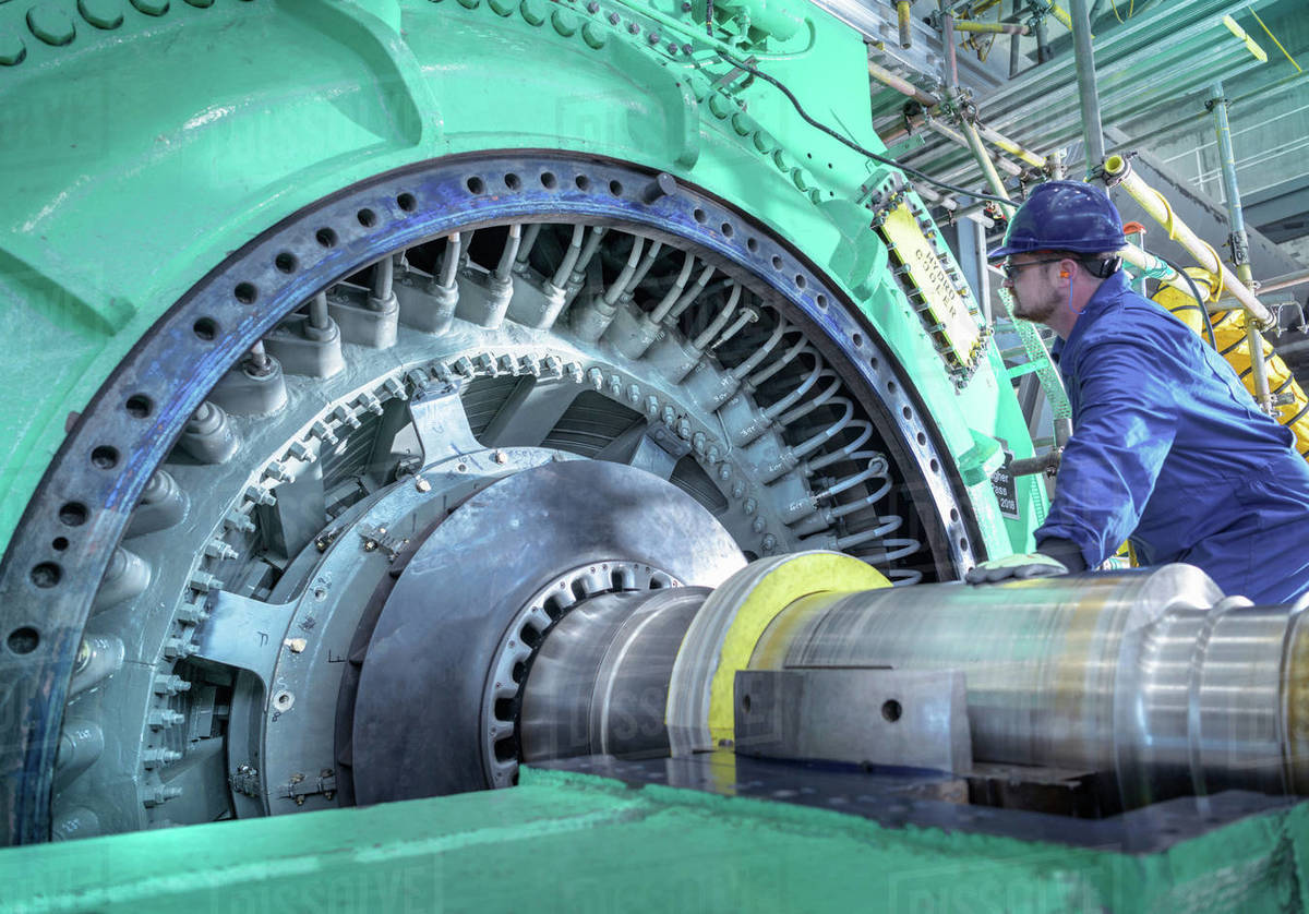 Engineer inspecting generator in nuclear power station during outage