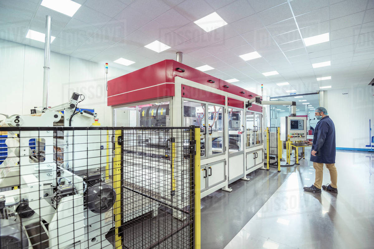 Worker with laser printing machine in print factory Royalty-free stock photo