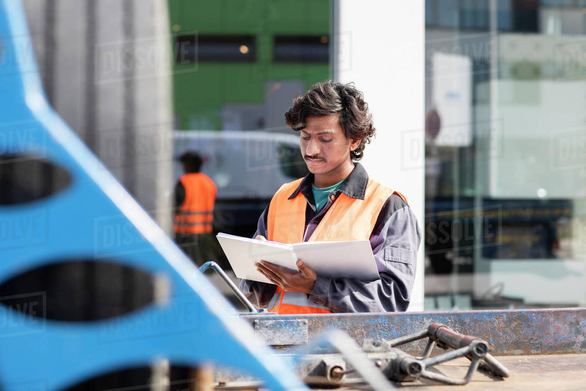 Male engineer on construction site writing in notebook Royalty-free stock photo