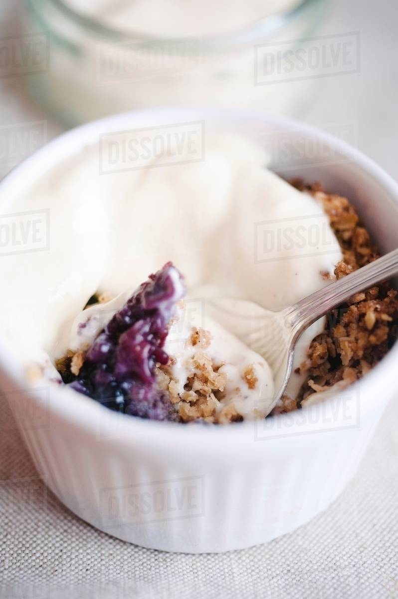 Fruit crumble in ramekin Stock Photo Dissolve