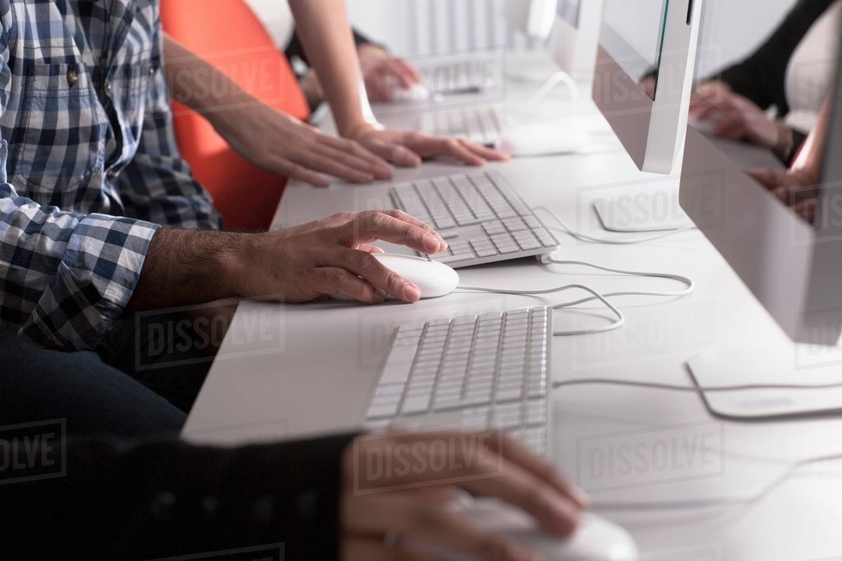 People using computers at desk - Royalty-free Stock Photo | Dissolve