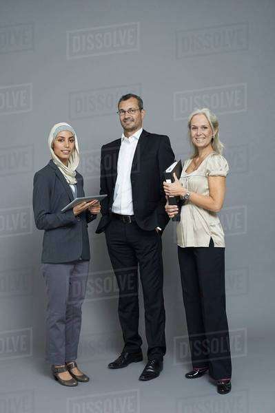 Studio portrait of two businesswomen and businessman - Royalty-free ...