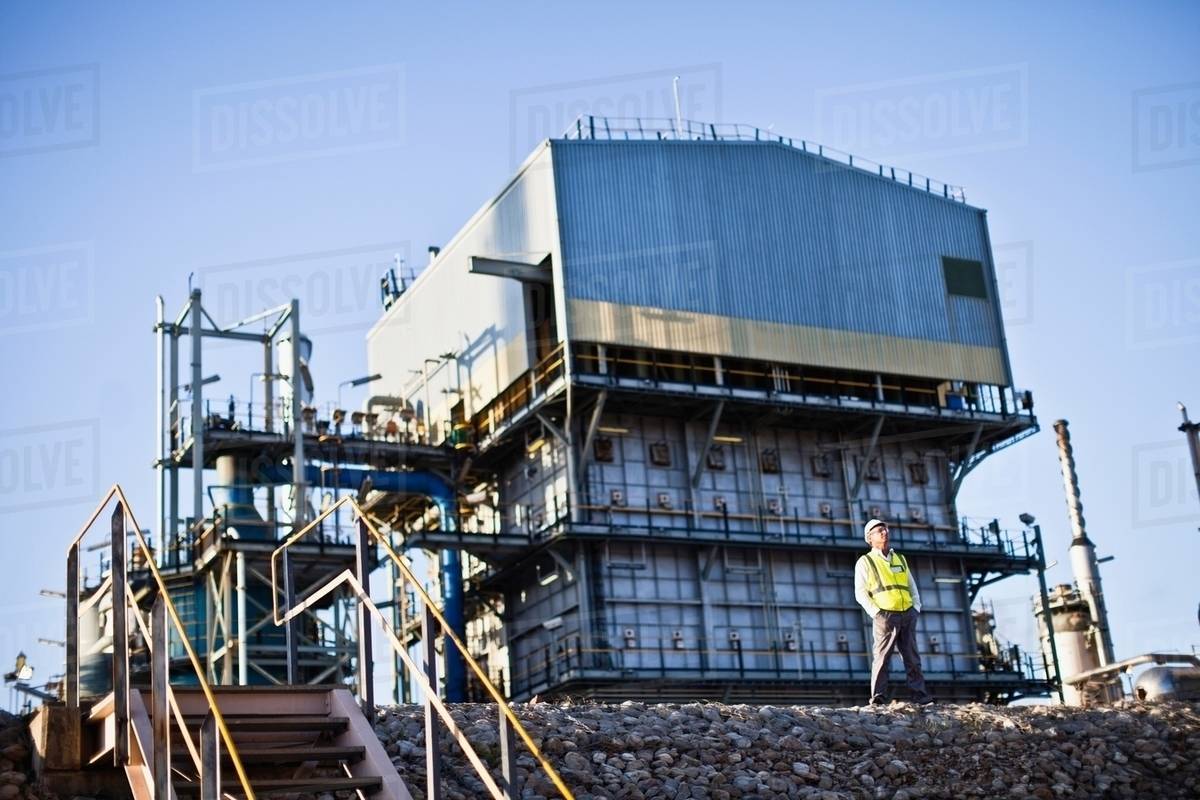 worker-standing-at-chemical-plant-stock-photo-dissolve