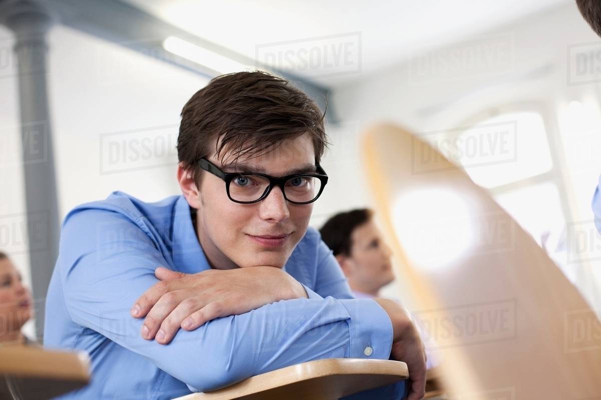 Businessman resting chin on arms Stock Photo Dissolve