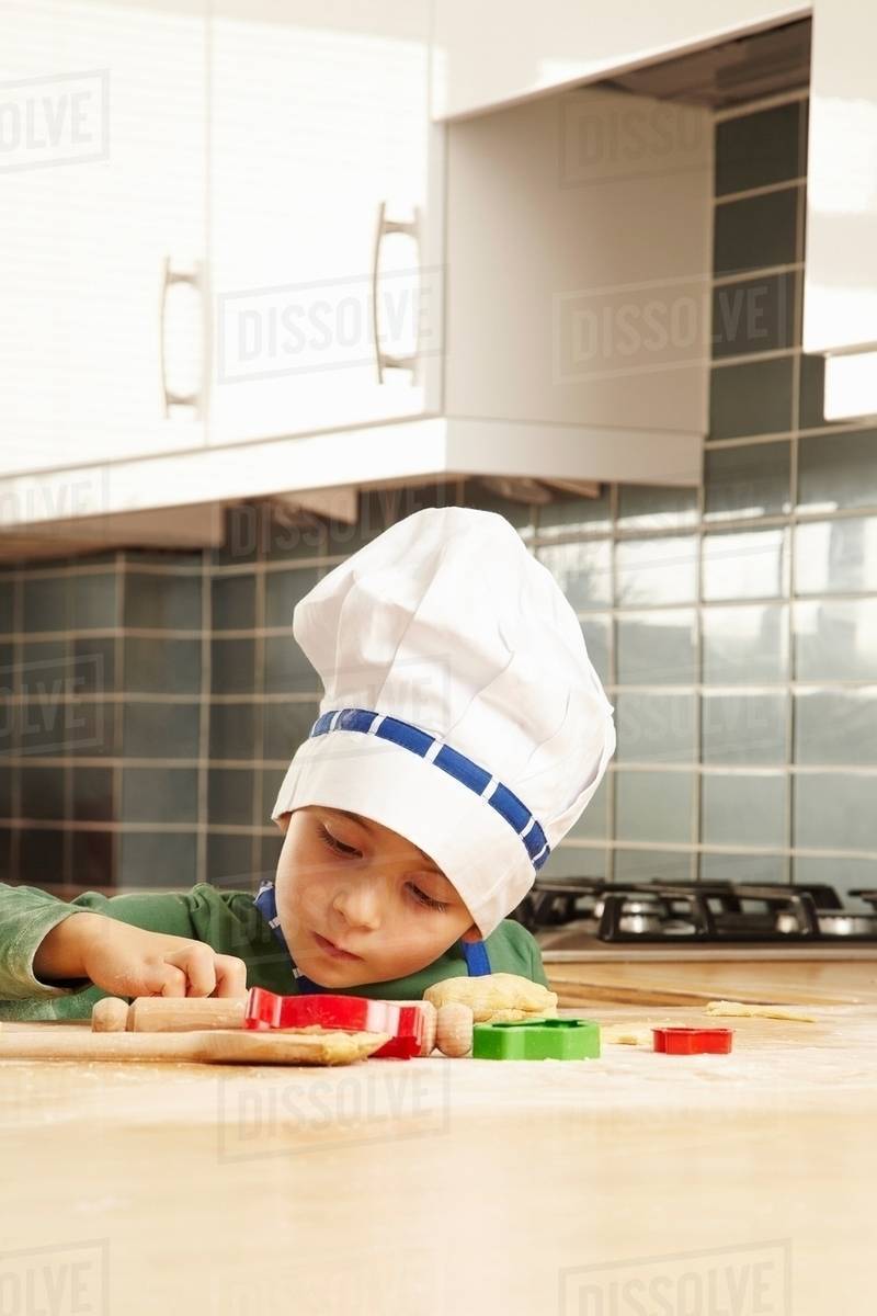 Young boy cooking in kitchen Stock Photo Dissolve