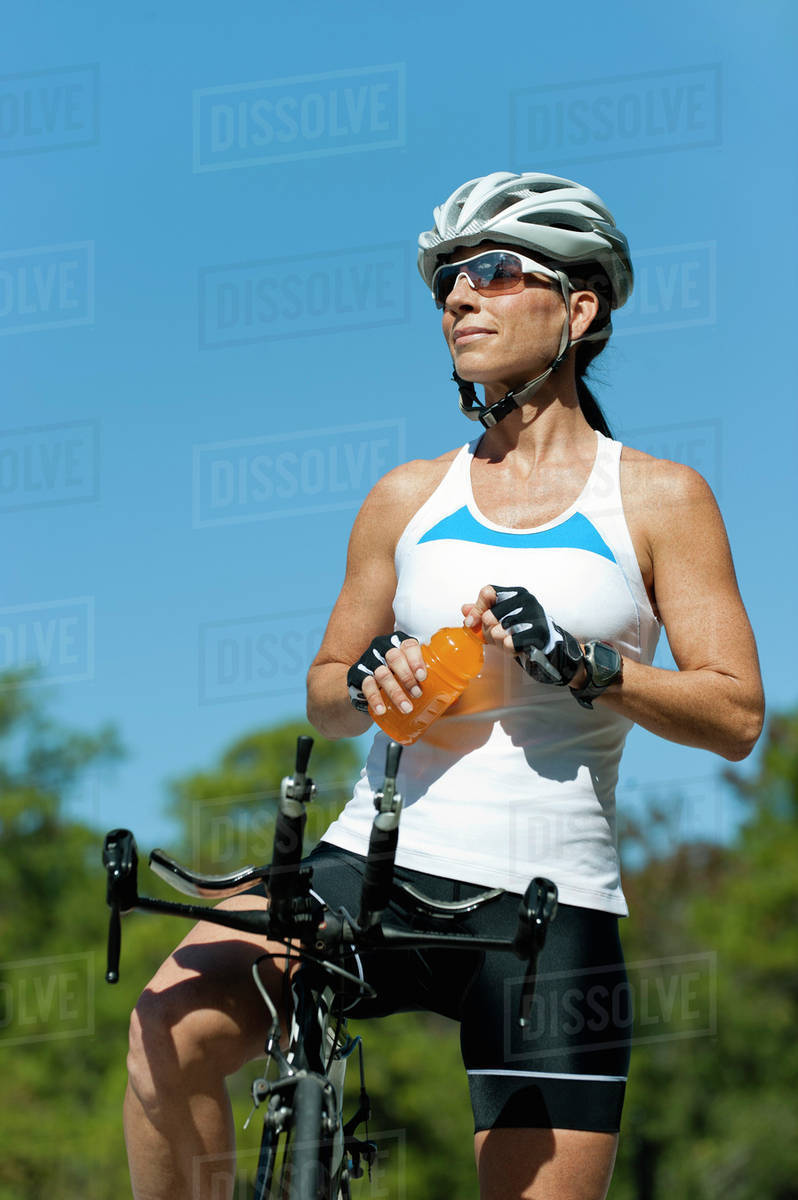 Female cyclist taking break Stock Photo Dissolve