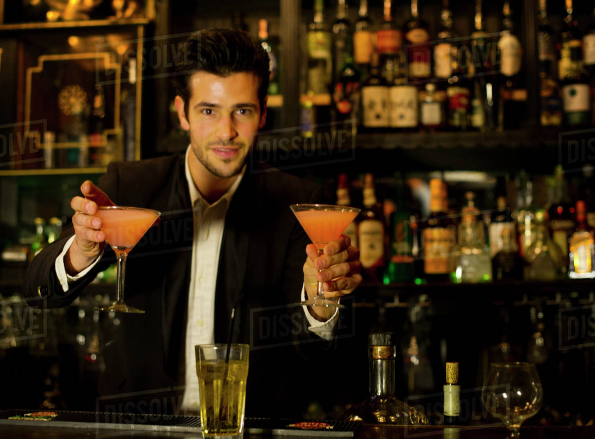 Bartender serving cocktails Stock Photo Dissolve