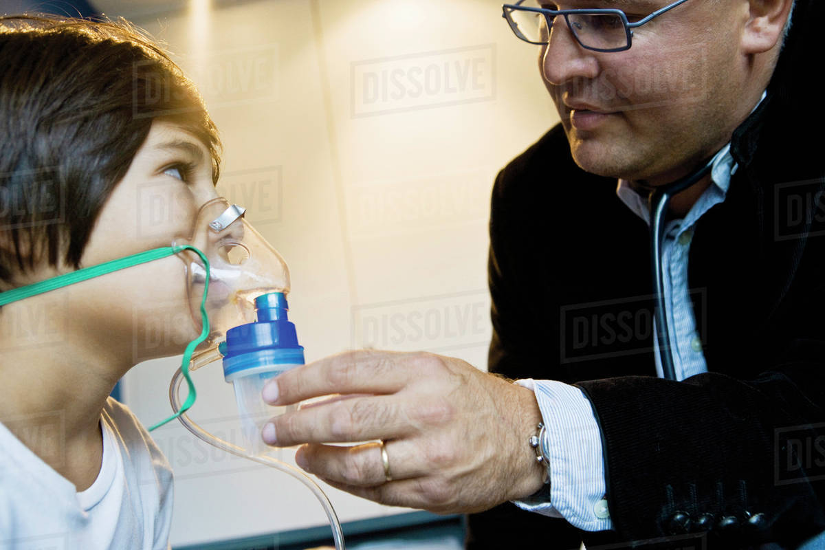 Boy receiving oxygen treatment Stock Photo Dissolve