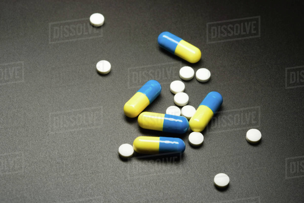 Pills and capsules, closeup Stock Photo Dissolve