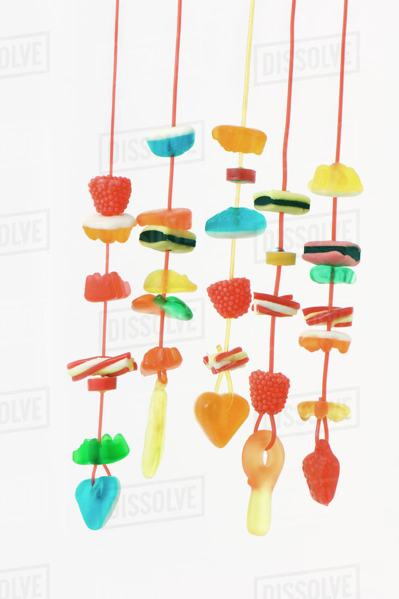 Strings of colorful candy Stock Photo Dissolve