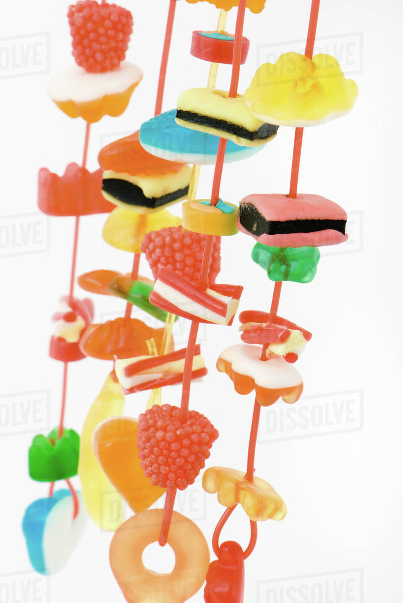 Colorful candy hanging on strings Stock Photo Dissolve