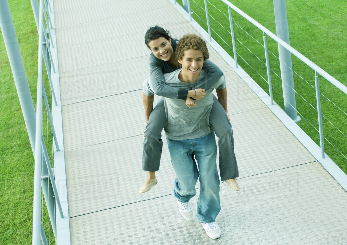 teenage couple boy carrying