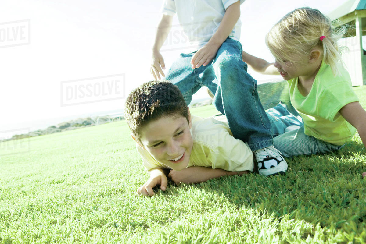Children playing on grass Stock Photo Dissolve