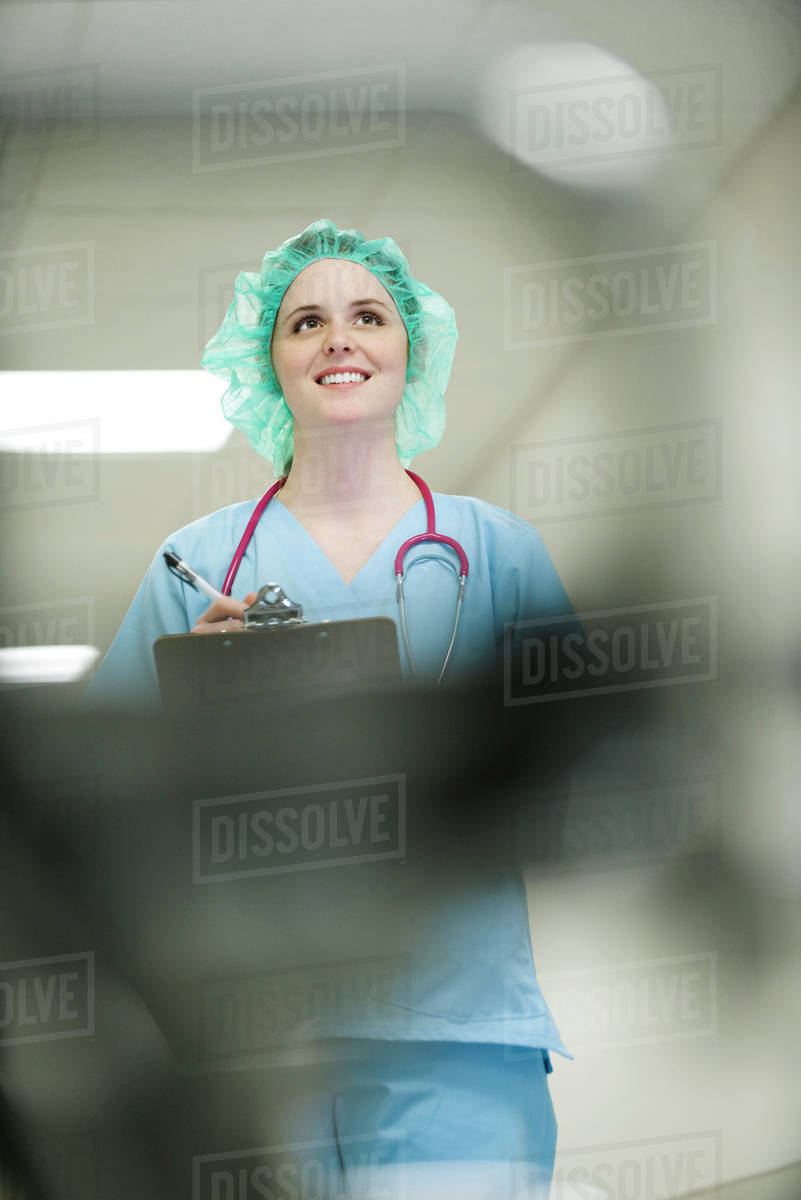 Nurse wearing surgical cap, low angle view Stock Photo Dissolve